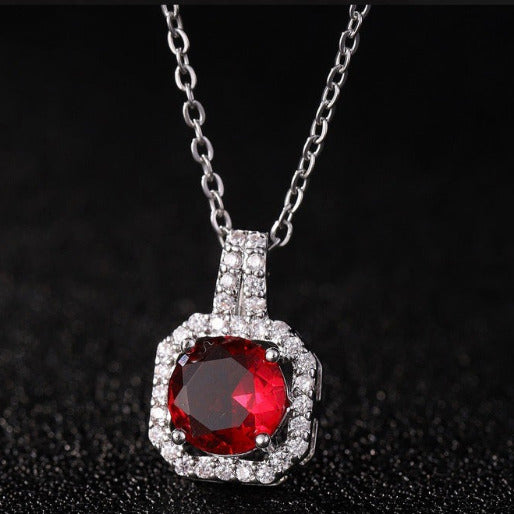Necklace with a red gemstone pendant on a black background