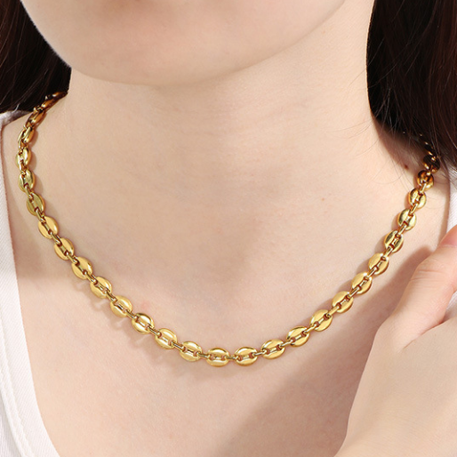 Gold Gucci Puff chain necklace being worn on a person's neck