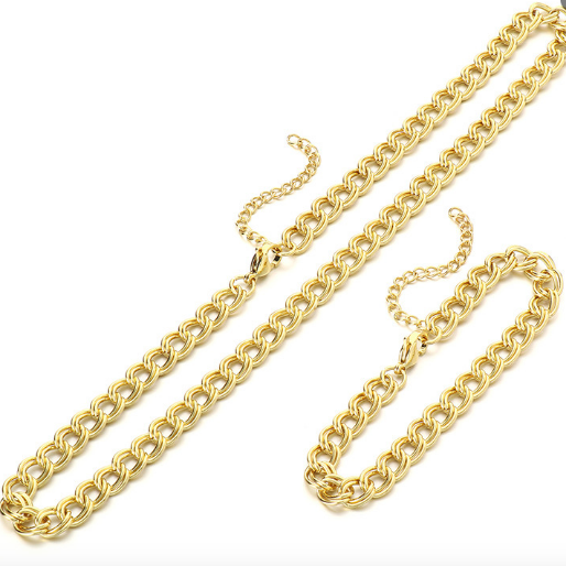 Gold chain necklace and bracelet on a white background