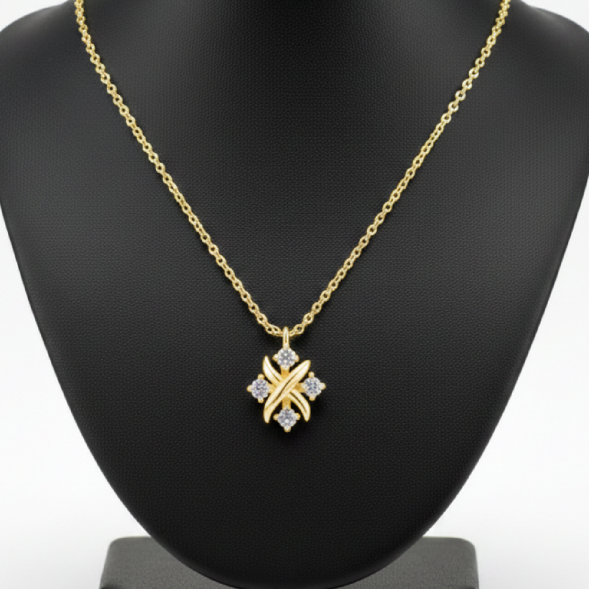 Gold necklace with a star-shaped pendant on a white background