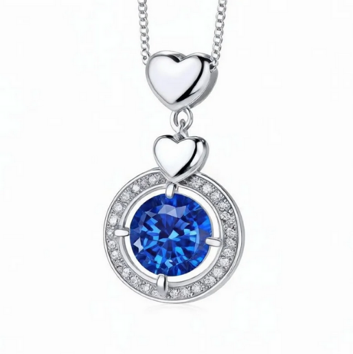 Silver necklace with heart pendants and a blue moissanite on a white background