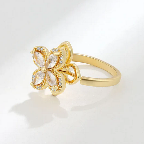 The unique feature of this ring is the spinning top, which allows the flower element to rotate independently, providing a discreet way to manage anxiety, aid focus, or simply provide a tactile distraction.