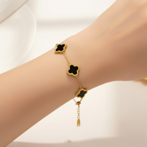 Clover motif bracelet with multiple clover-shaped motifs, each crafted with a black inlay surrounded by a golden outline.