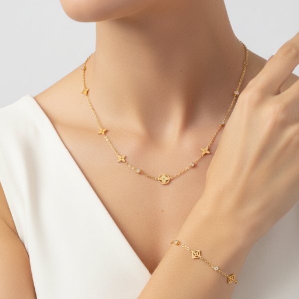 Gold-toned fashion jewelry set comprising a necklace and a matching bracelet. The jewelry is crafted from Titanium, offering durability and resistance to tarnish, making it a stylish and accessible accessory fir everyday ear or special occasions.