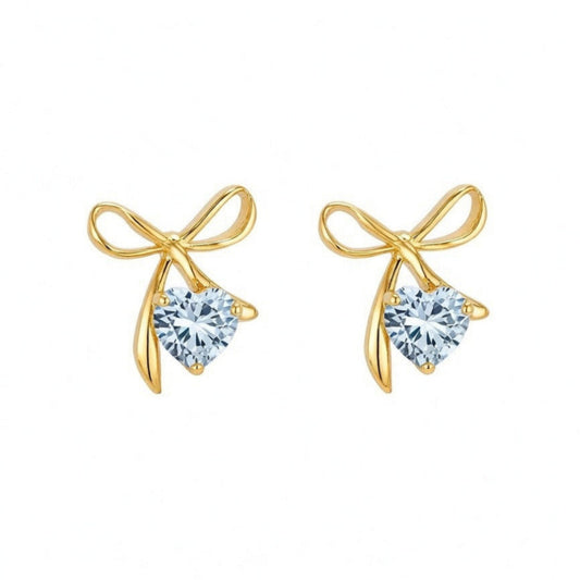 Gold bow-shaped earrings with heart-shaped gemstones on a white background