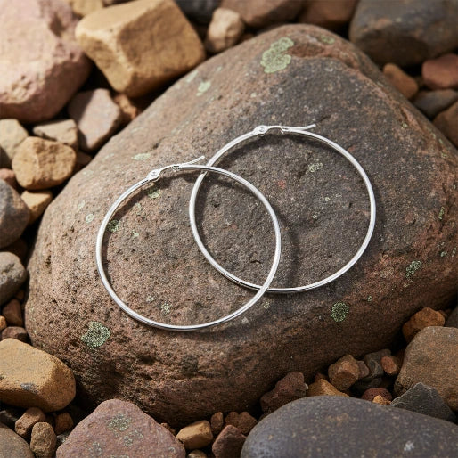 These earrings are secured with a hinged post mechanism, commonly known as French lock or snap closure, designed for secure and comfortable wear. 